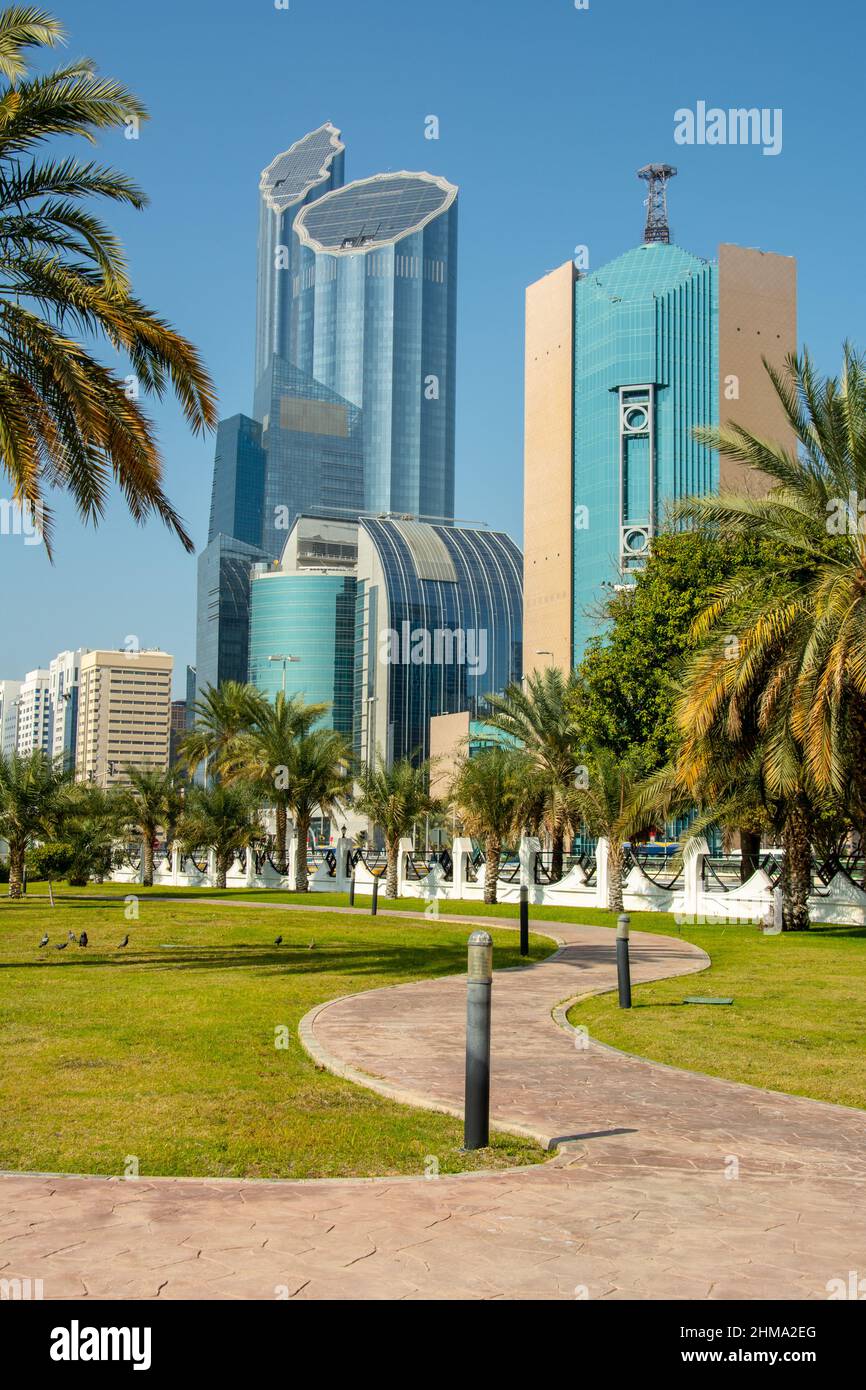 The 30-storey Etisalat Abu Dhabi tower with a huge ball on the roof seen through the palm trees in Abu Dhabi Stock Photo