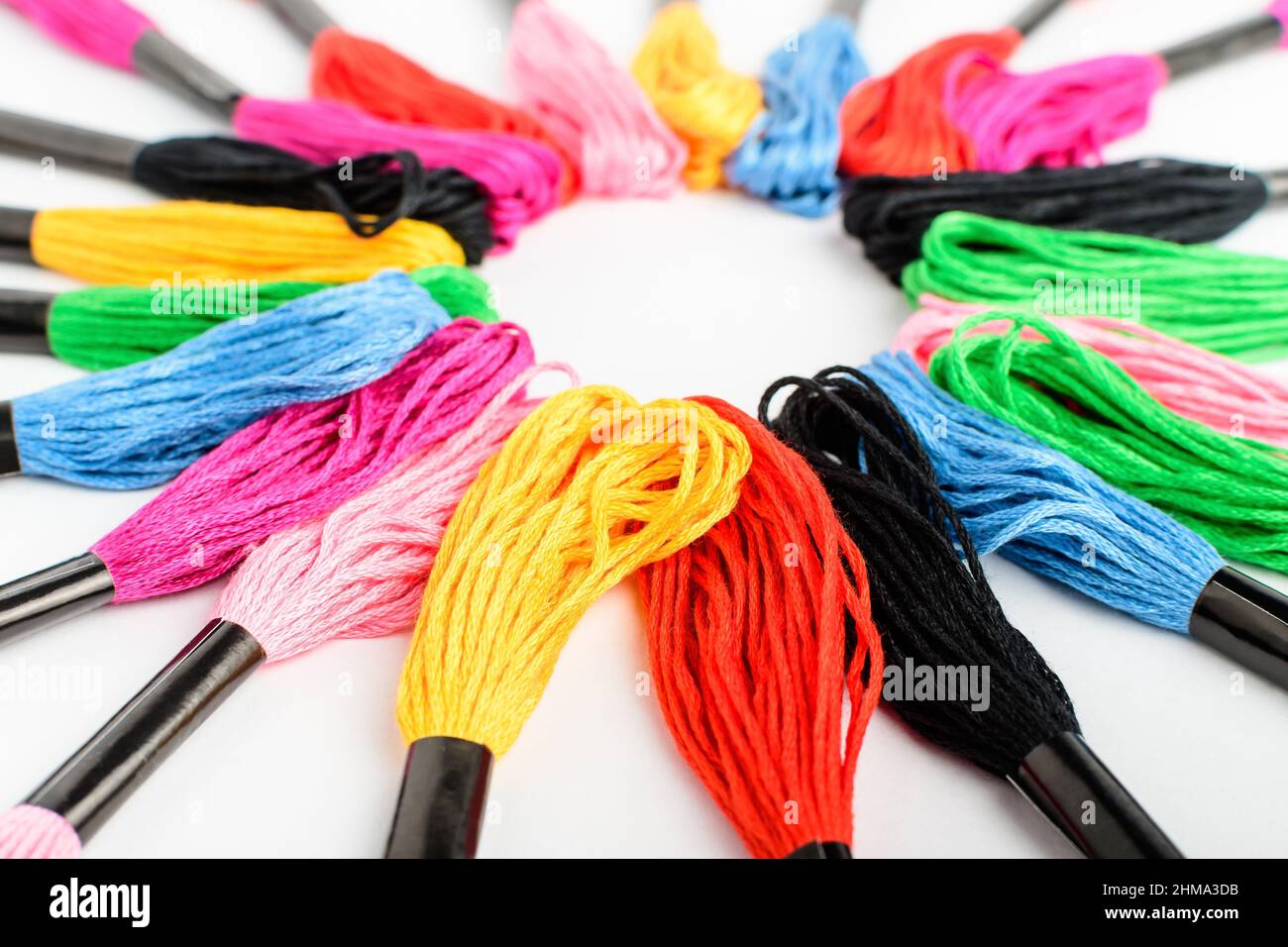 Many mixed vivid colored sewing threads for embroidery displayed in a ...