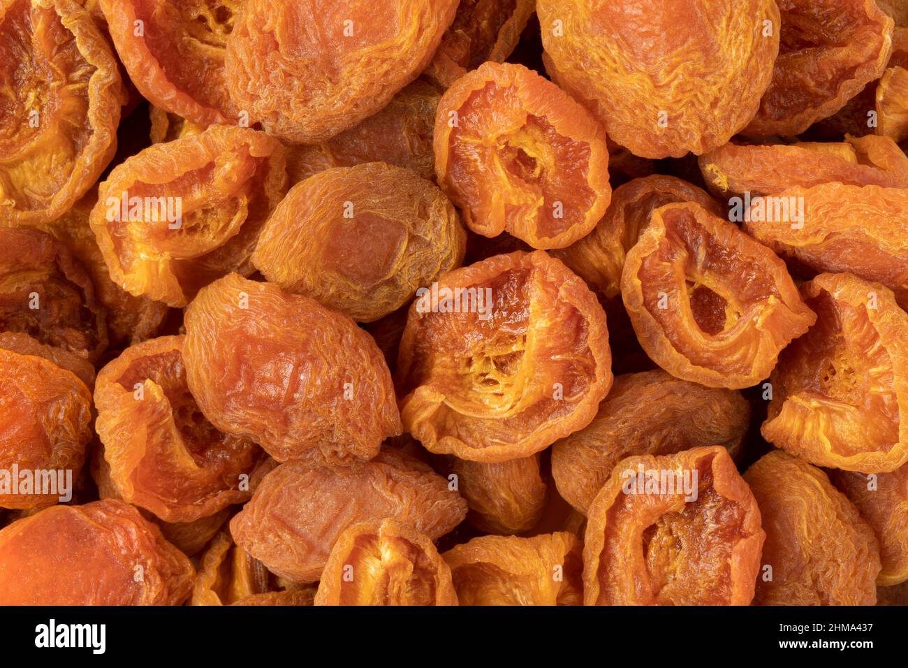 Dried small sour apricots close up full frame as background Stock Photo
