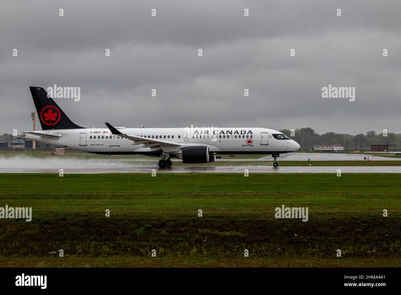Montreal, Quebec, Canada 10-02-2021: Air Canada Airbus A220-300 fin 114, registration C-GMZY. Taking off from Montreal on a rainy day. Stock Photo