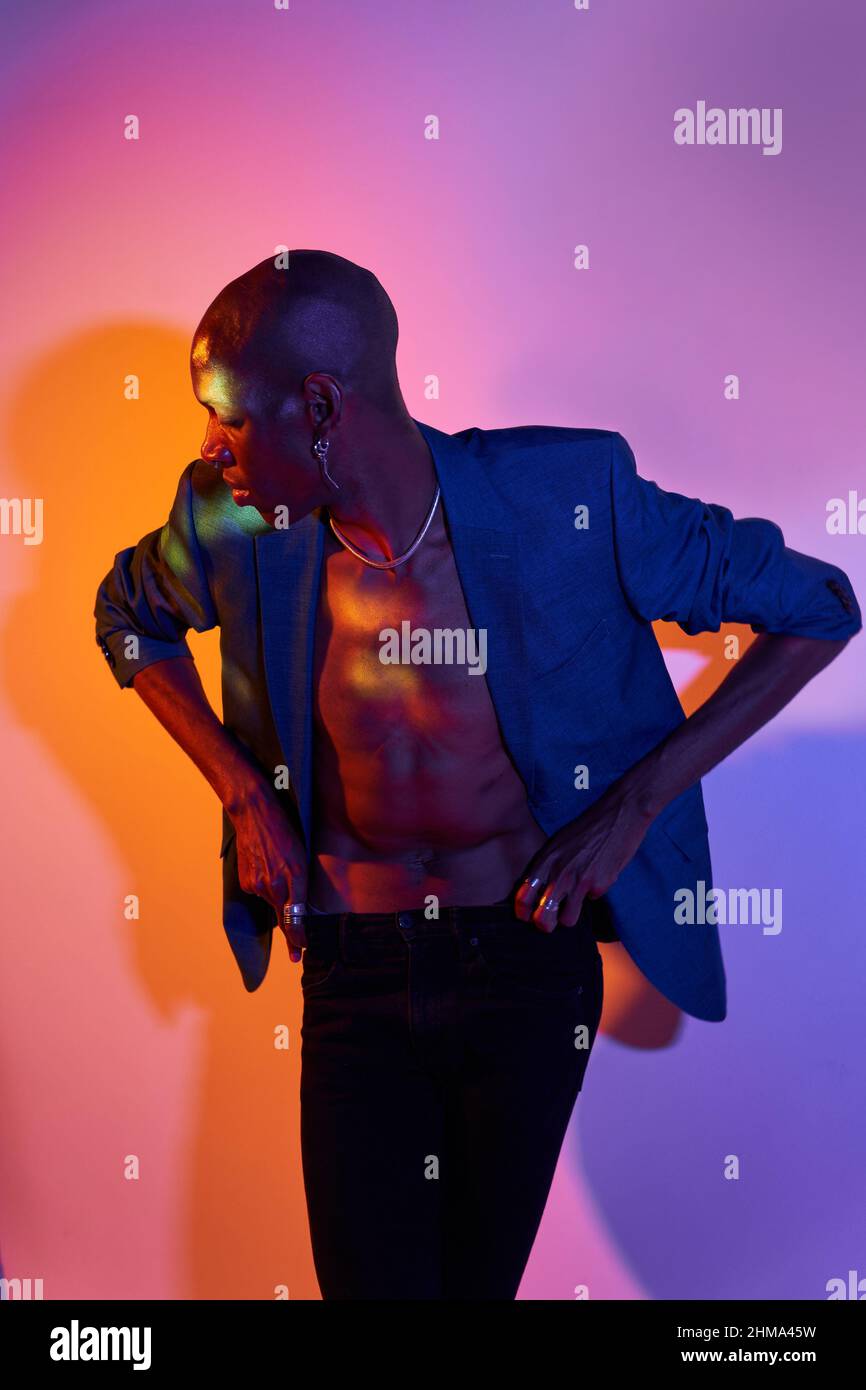 Confident Bald African American Slim Male Model With Necklace In Trendy confident-bald-african-american-slim-male-model-with-necklace-in-trendy