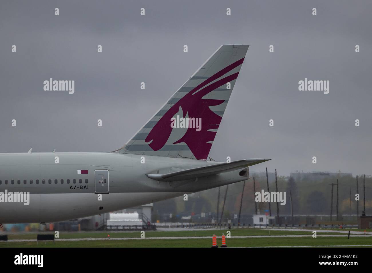 Montreal, Quebec, Canada 10-02-2021: The tail fin of a Qatar Boeing B777 landing in Montreal, arriving from Doha on a rainy afternoon. Registration A7 Stock Photo