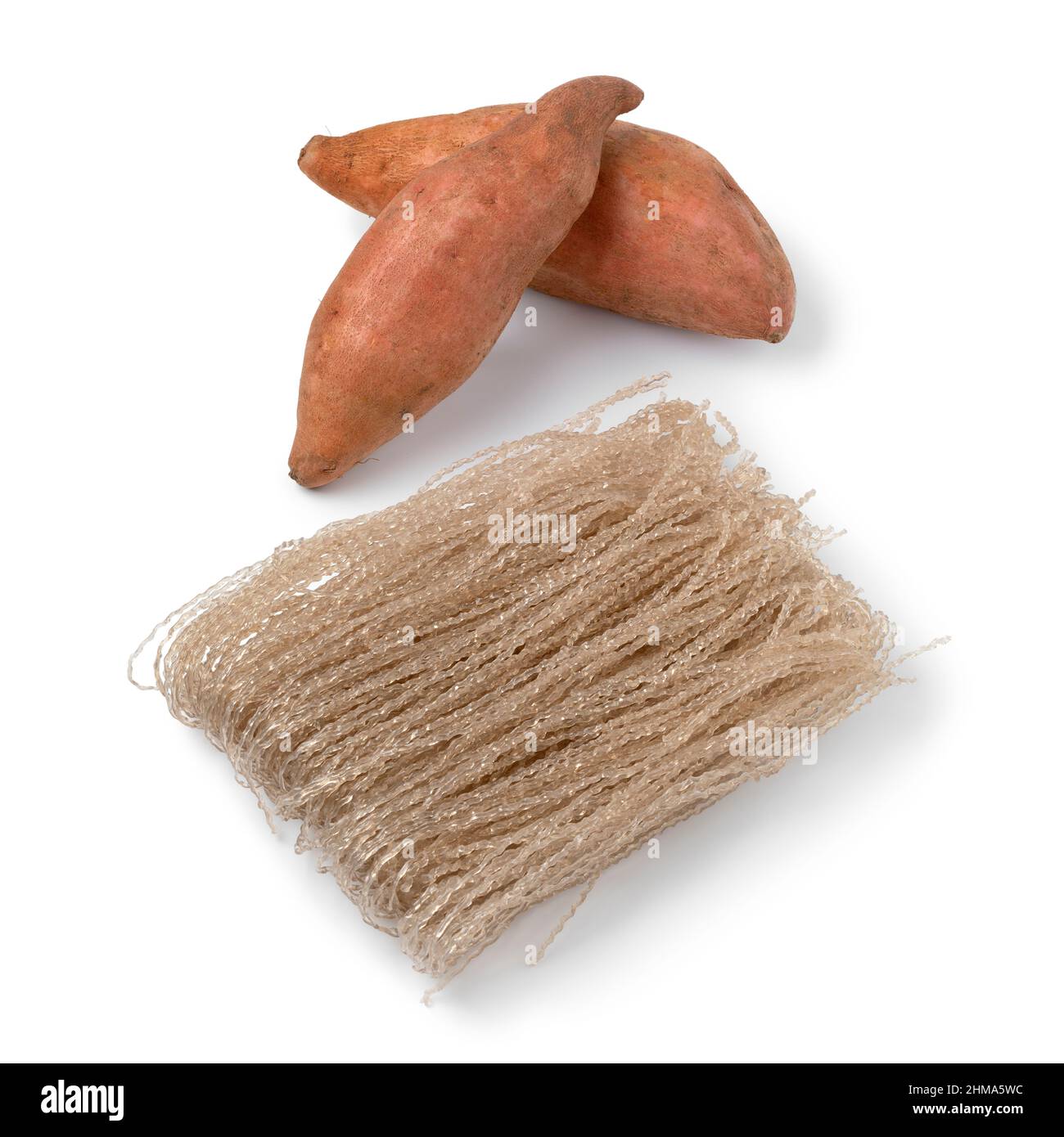 Sweet potato starch glass noodle, Dangmyeon, and fresh sweet potatoes isolated on white background Stock Photo