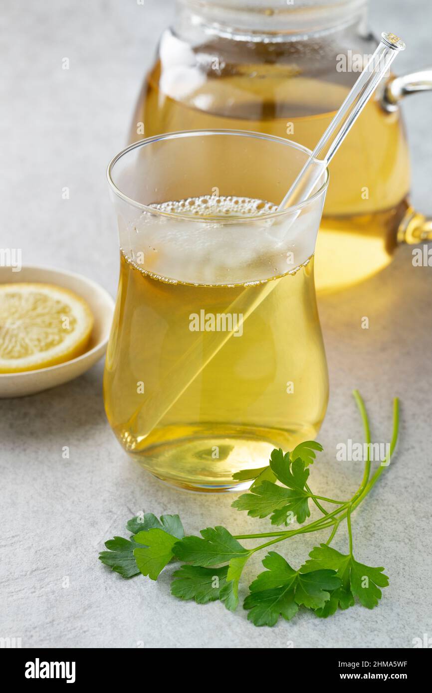 Glass with healthy fresh parsley tea close up Stock Photo