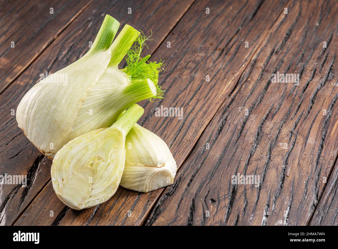 Florence fennel bulbs on aged wood background. Stock Photo