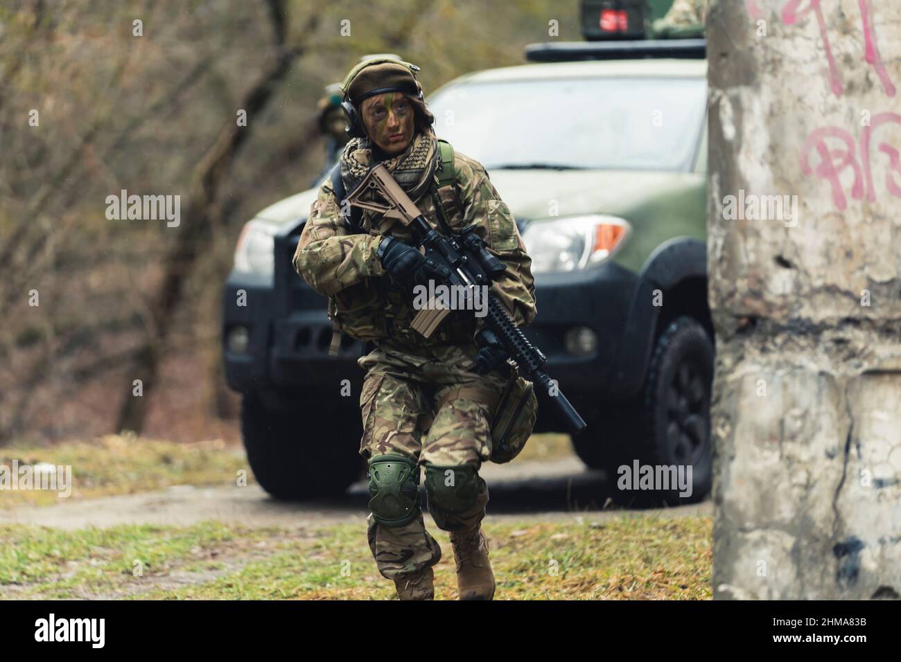 Anxious nervous female soldier confronting attackers slowly . High quality photo Stock Photo