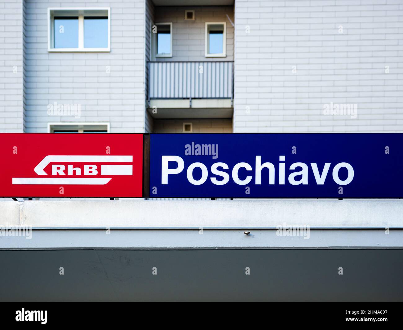 Poschiavo, Switzerland - January 19, 2022: A sign of the railway station of Poschiavo and a logo of Rhaetian railway, Unesco heritage Stock Photo