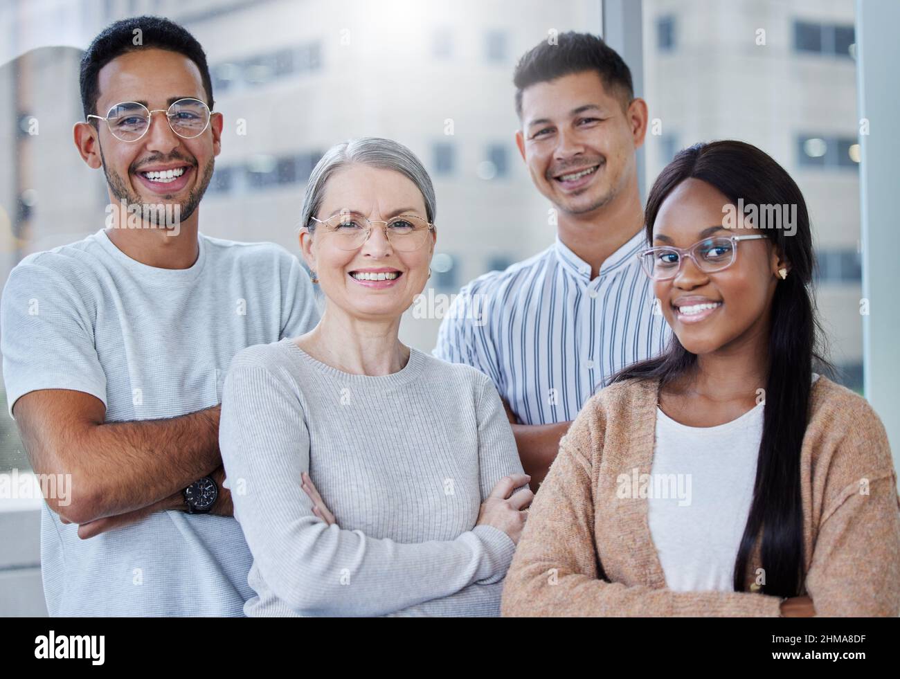 I have the best team in the business. Shot of a diverse team of coworkers together in their office at work. Stock Photo