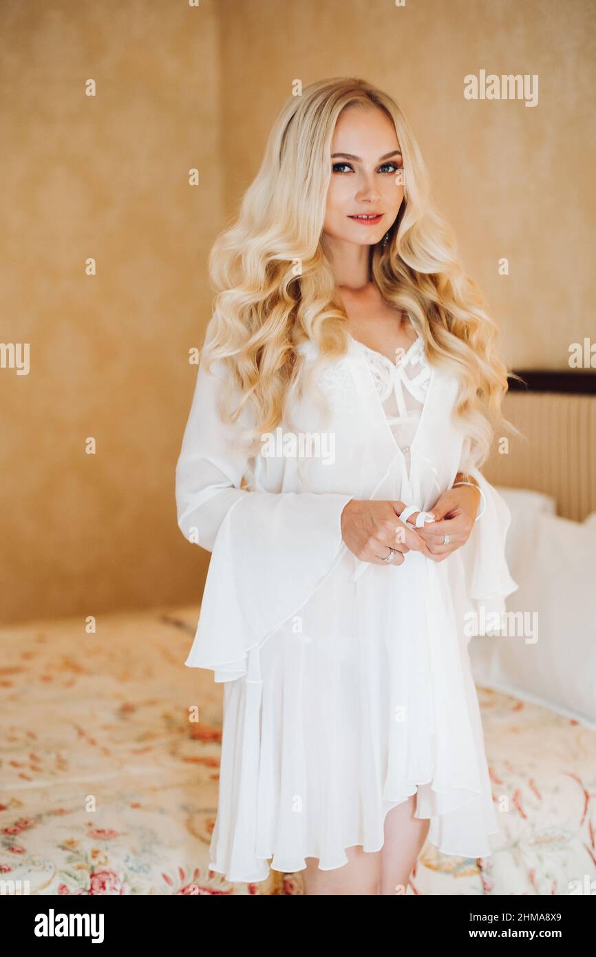 Sexy blondie bride in white lace lingerie undressing Stock Photo - Alamy
