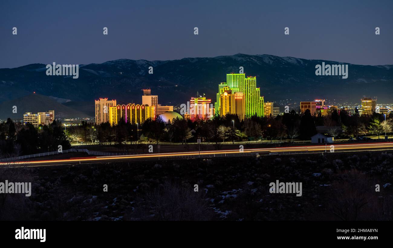 Reno, Nevada USA - February 6, 2022: Long exposure photograph of the City of Reno downtown district with Casinos, Hotels and light trails from traffic. Stock Photo