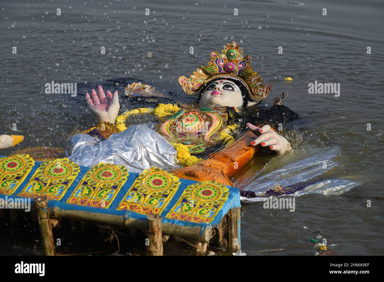 Floating Hindu goddess Saraswati idol for immersion on the Ganges after