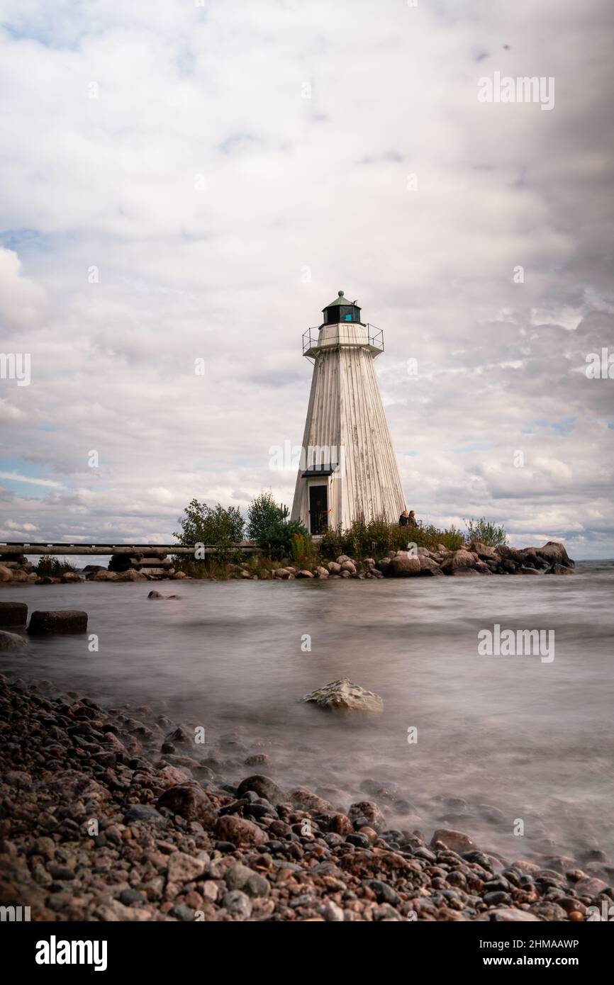 Vertical shot of a lighthouse in the river on a sunny day Stock Photo