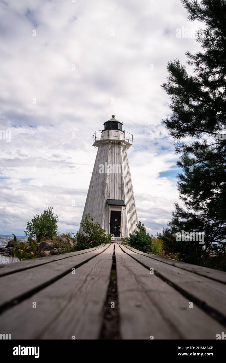 Vertical shot of a lighthouse near the river Stock Photo