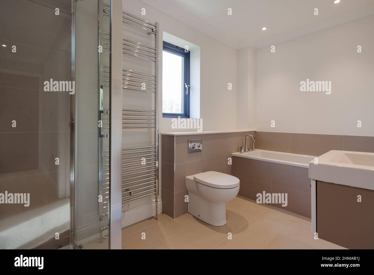 Great Wilbraham, Cambridgeshire, England - Feb 24 2017: Brand new luxury shower bathroom within vacant just finished property with cubicle  bath tub a Stock Photo