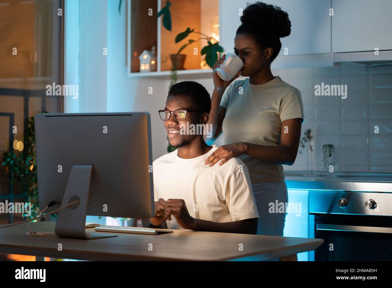 Wife support husband web programmer in creating app or website design for freelance project at home Stock Photo