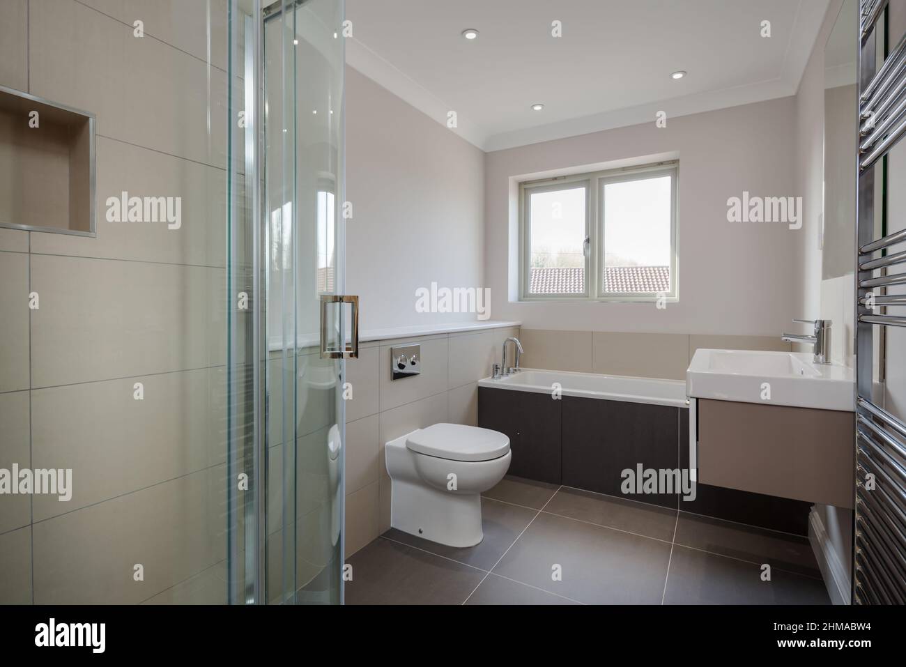 Great Wilbraham, Cambridgeshire, England - March 27 2017: Brand new bathroom and shower room within vacant just finished property with tiled cubicle a Stock Photo