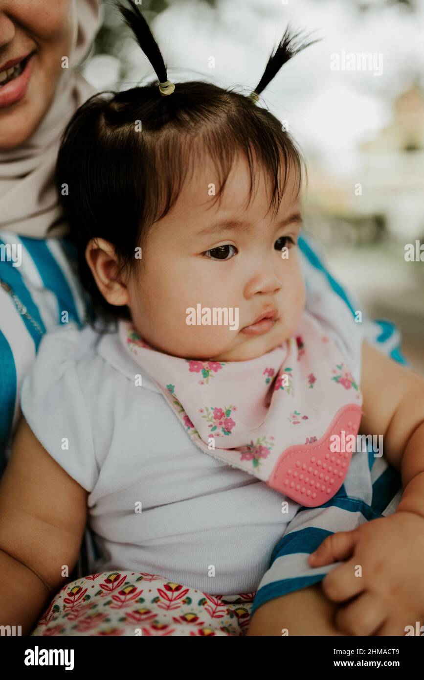 Mother holding her baby girl Stock Photo