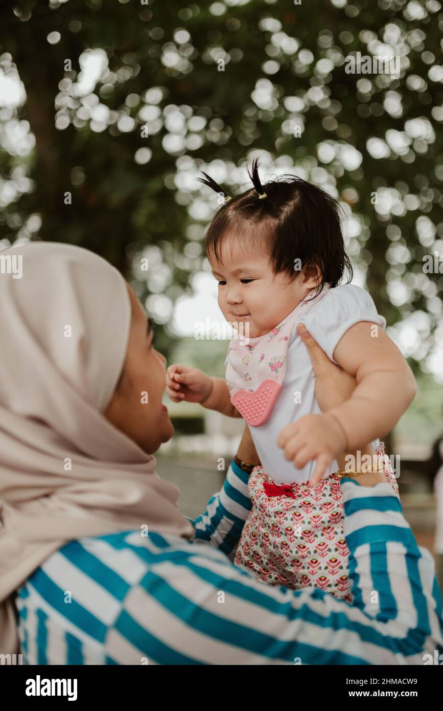 Mother holding her baby girl Stock Photo