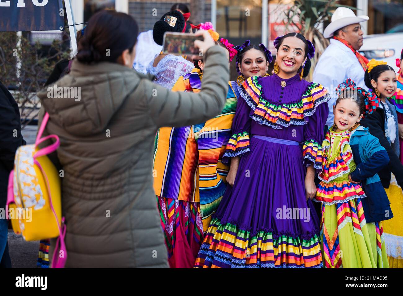 spectator taking pictures of folklorico dancers Stock Photo