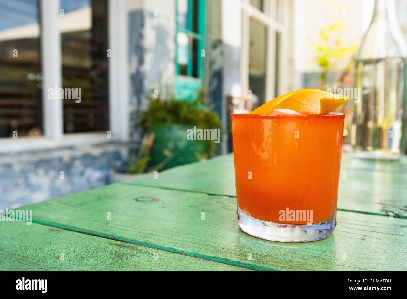 A cocktail rests on an outdoor table at a Charleston restaurant Stock Photo