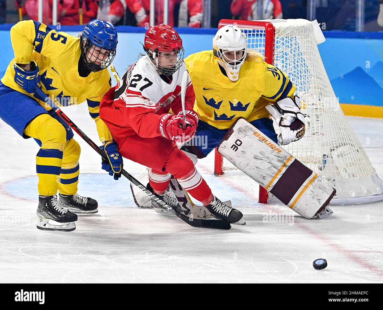 Beijing, China. 8th Feb, 2022. Johanna Fallman (L) of Sweden and  gooalkeeper Emma Soderberg (R) of Sweden compete with Lilli Friis-Hansen of  Denmark during the ice hockey women's Group B match between