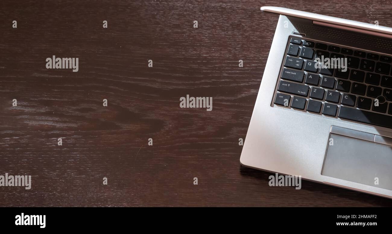 Laptop computer on a wooden table, empty space, high angle view. Workspace, home office work concept Stock Photo
