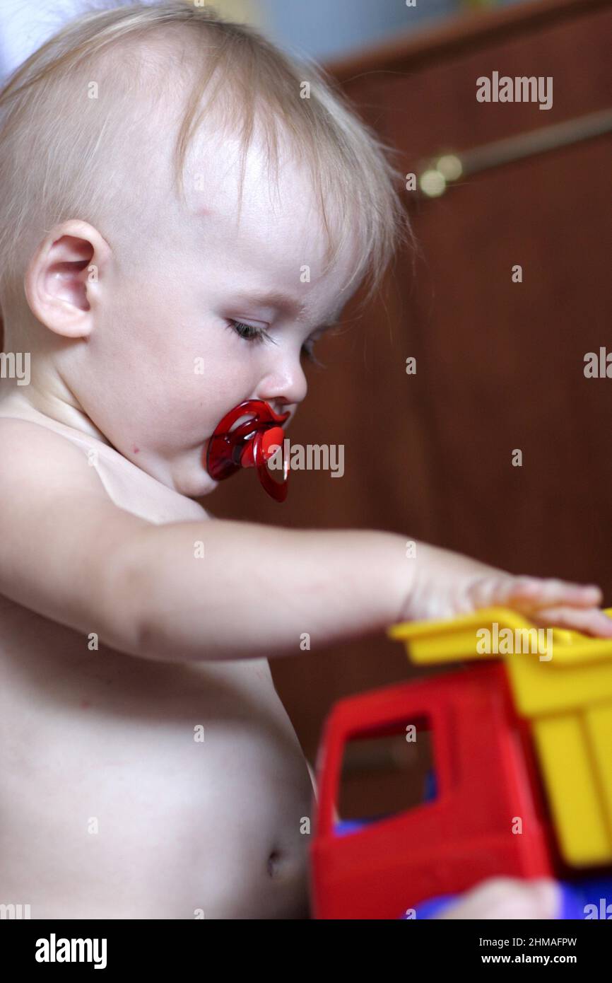The baby plays with toy car at home Stock Photo - Alamy