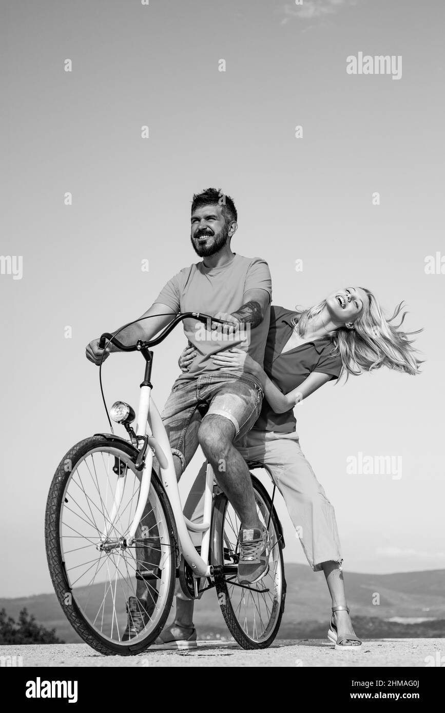 Travel Vacation concept. Young couple in love having fun and enjoying. Happy funny young couple riding on bicycle. Happy young couple riding bicycles. Stock Photo