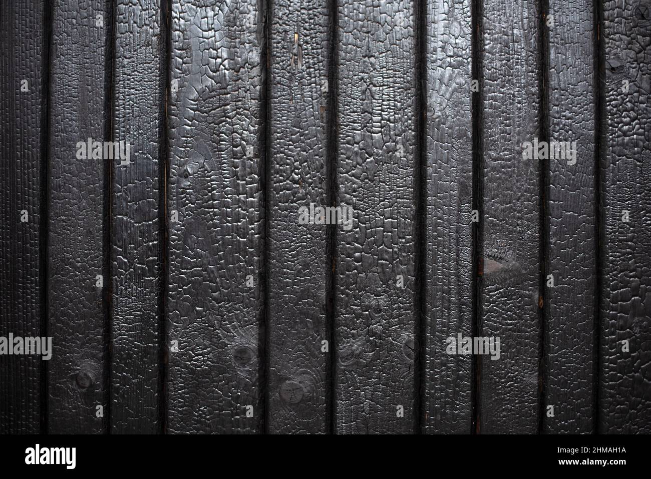 Burnt wood background texture. Burnt wooden boards closeup. Sho-Sugi-Ban Yakisugi, traditional Japanese method of wood preservation. Stock Photo