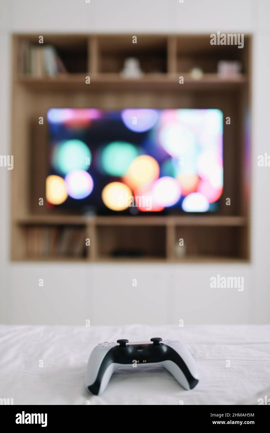 Game controller, joystick on TV screen background. Playing game console