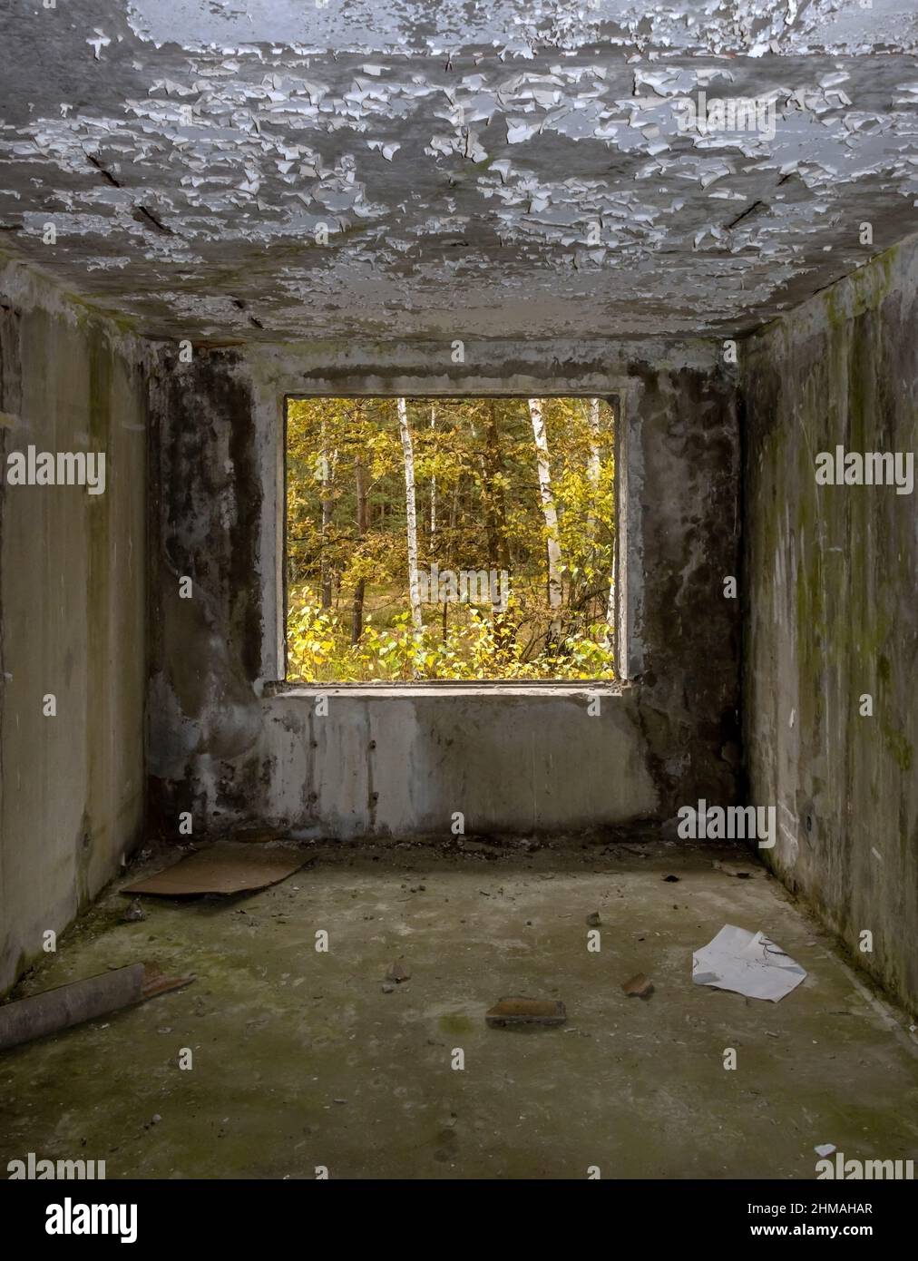 View through the hole for a windows in a damaged abandoned panel house. Stock Photo