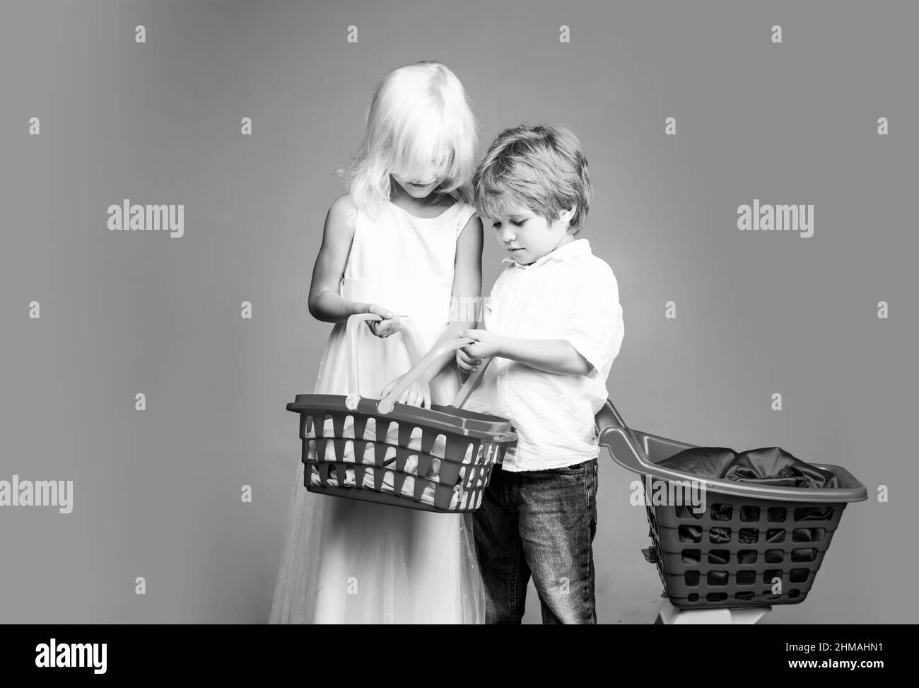 Mall shopping. Buy products. Play shop game. Cute buyer customer client hold shopping cart. Girl and boy children shopping. Kids store. Couple kids Stock Photo