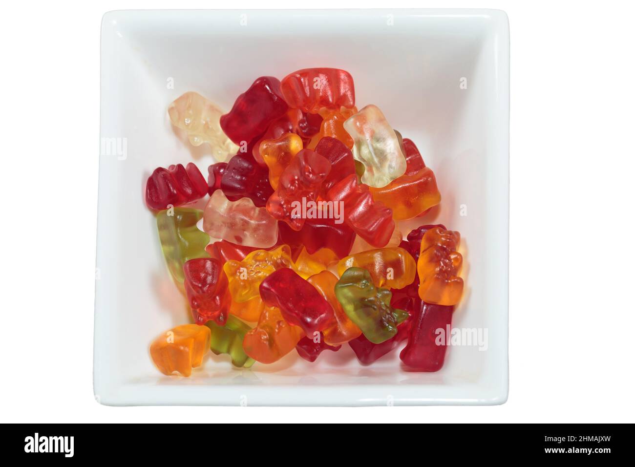 Delicious gummy bears in a square bowl. It is isolated on a white background. Close-up. Stock Photo