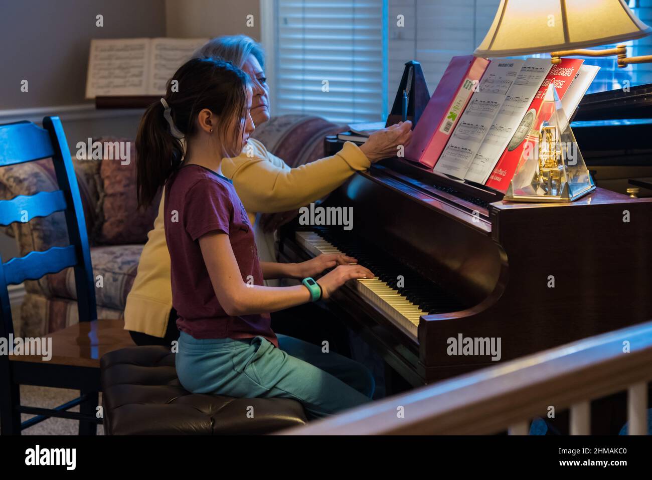 South Jordan, Utah, USA, Feb. 7, 2022.  A skilled piano teacher inspires as well as instructs.  Learning to play requires dedication and commitment Stock Photo