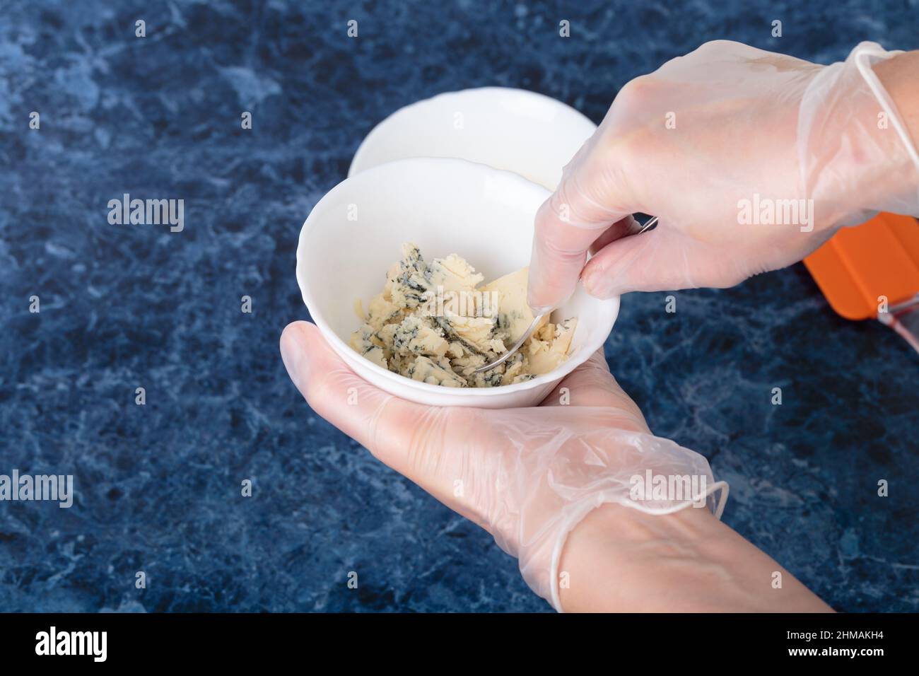 Hands using a cheese grater Stock Photo - Alamy