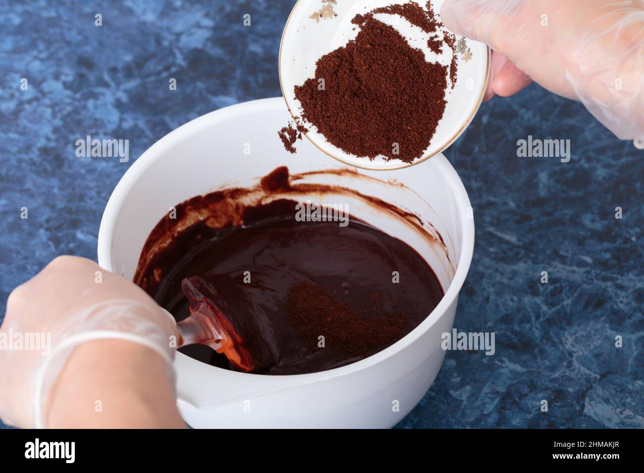 Adding coarse coffee to hot chocolate. This process takes place in a