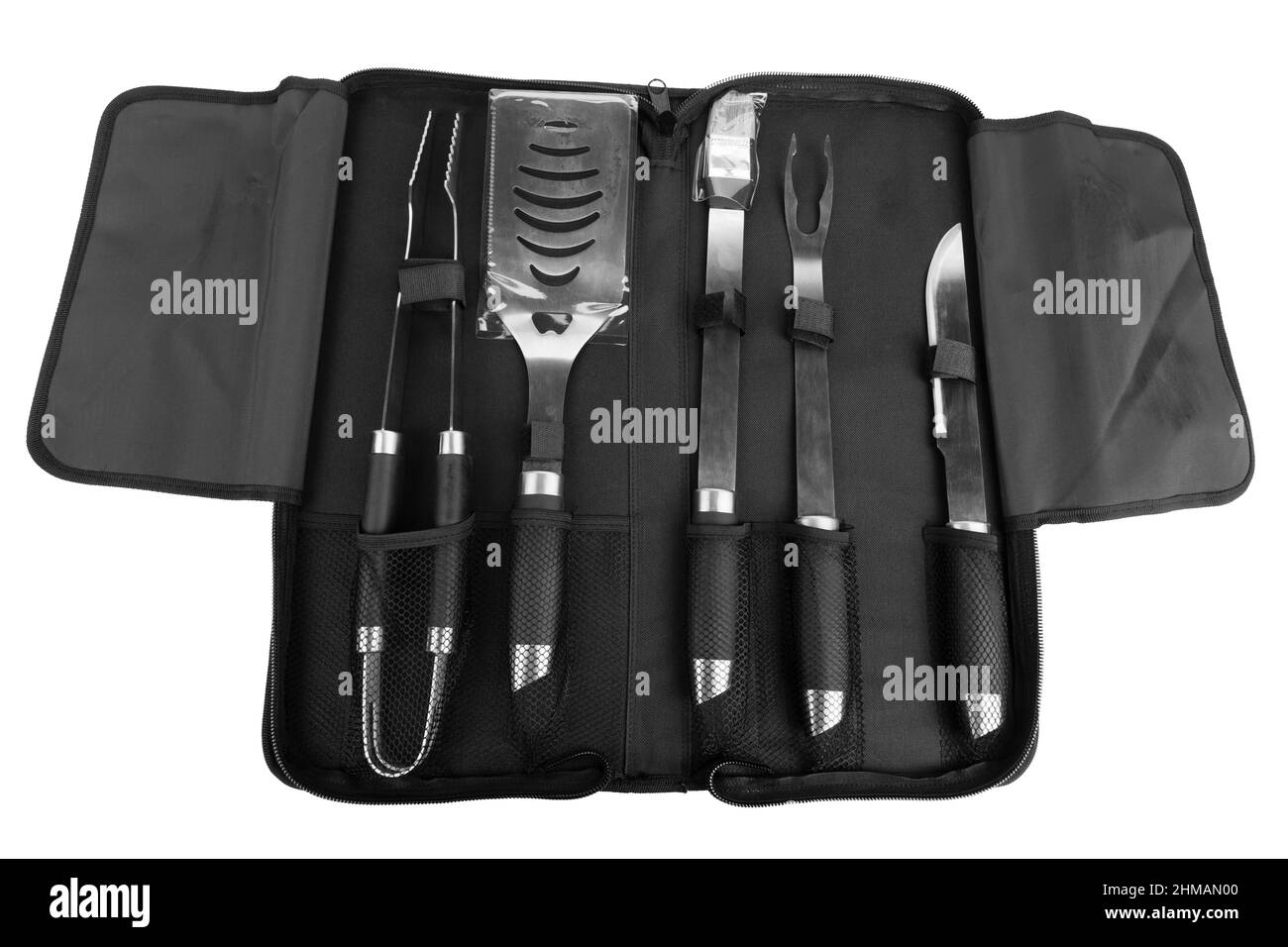 Set of tools for bbq in black bag. Isolated over white background. Close-up. Stock Photo
