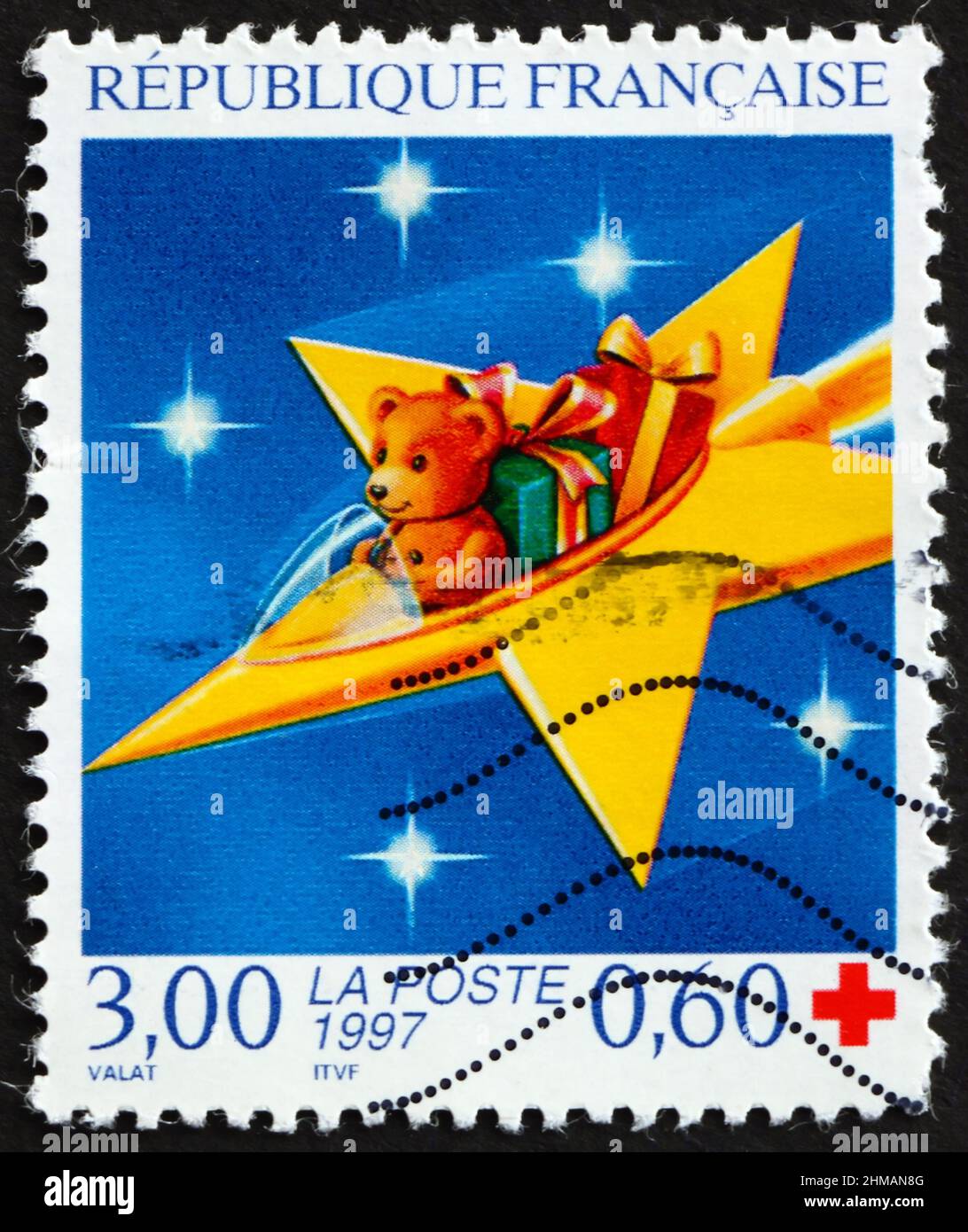 FRANCE - CIRCA 1997: a stamp printed in France shows teddy bear with gifts, circa 1997 Stock Photo