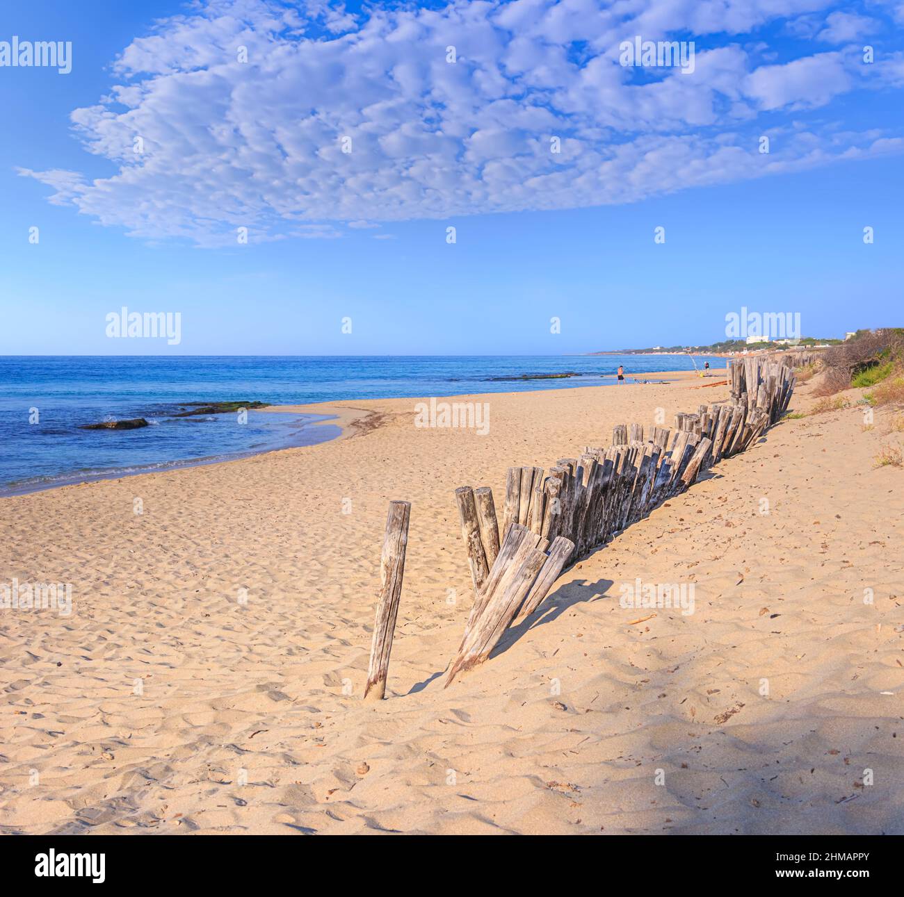 Summertime: fence on the beach in Puglia, Italy: the sandy beach of San Pietro in Bevagna, a natural oasis in front of the blue Ionian sea,. Stock Photo