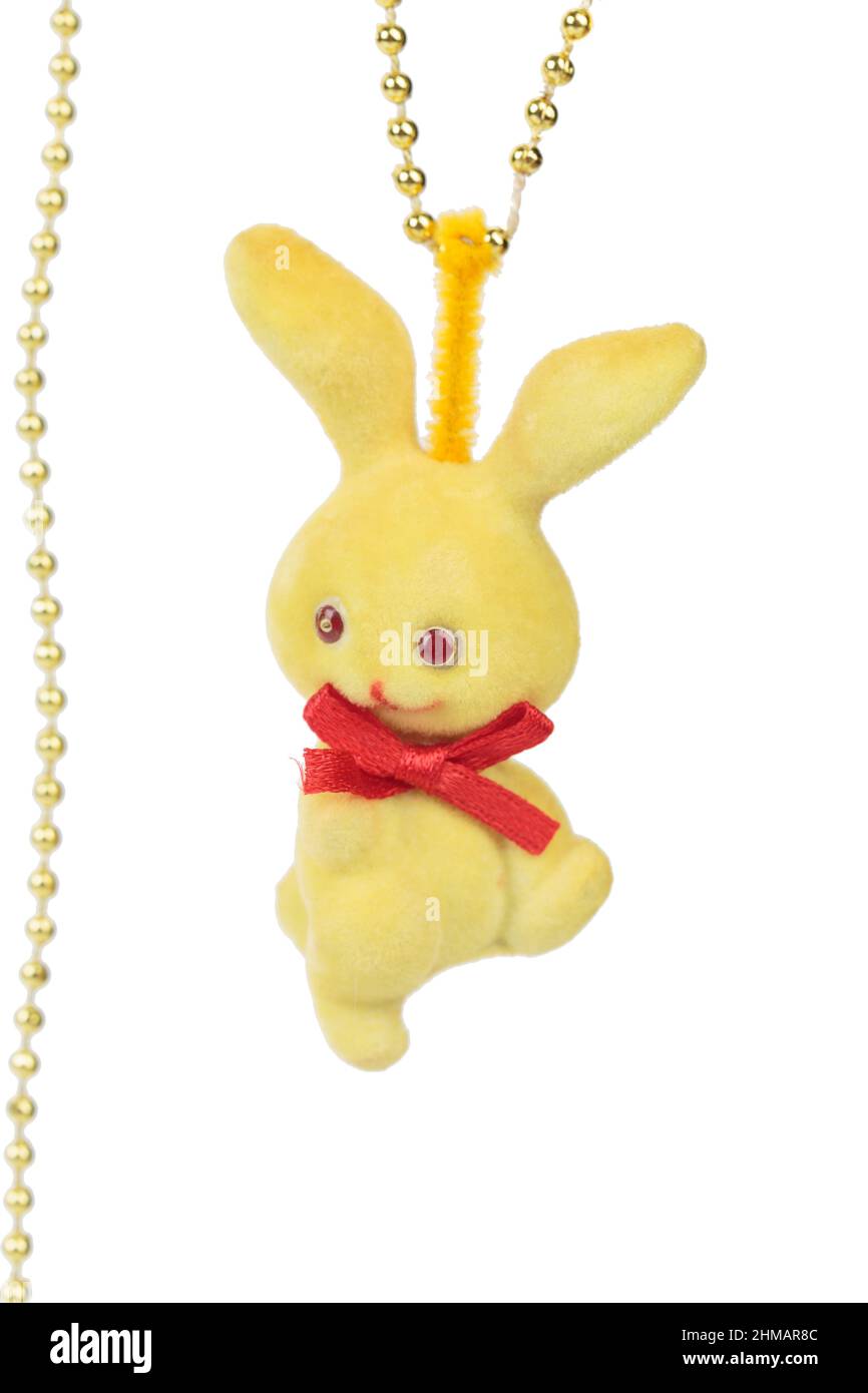 Handmade yellow rabbit toy with a red bow. Isolated over white ...