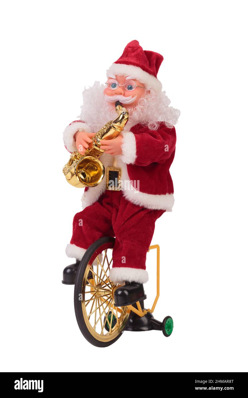 Santa Claus on a bicycle with a saxophone. Isolated over white background. Close-up. Stock Photo