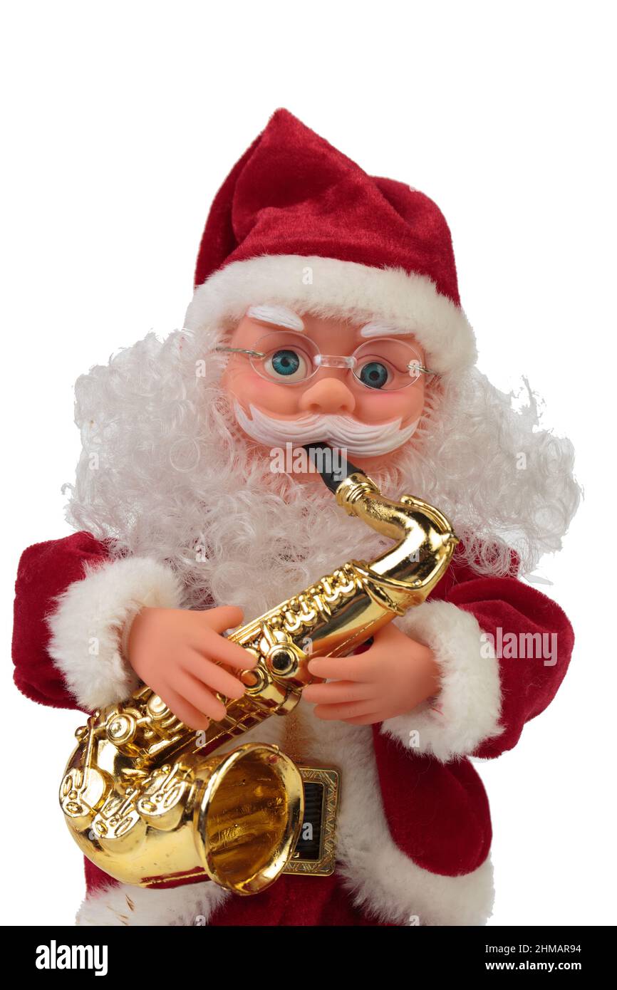 Santa Claus doll with saxophone. Isolated over white background. Close-up. Stock Photo