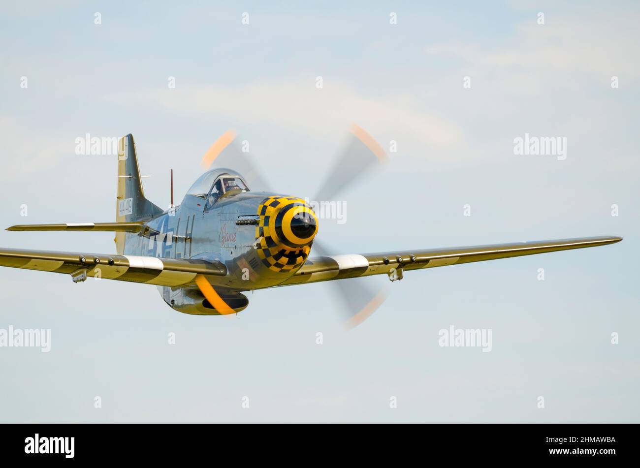 North American P-51 Mustang fighter plane called Janie, flying fast and low. Owned by Maurice Hammond and flown by Dave Evans. Stock Photo