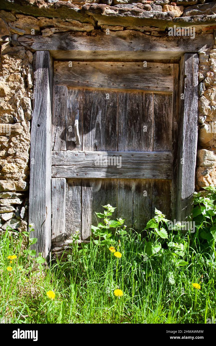 old stone house overgrown door Stock Photo