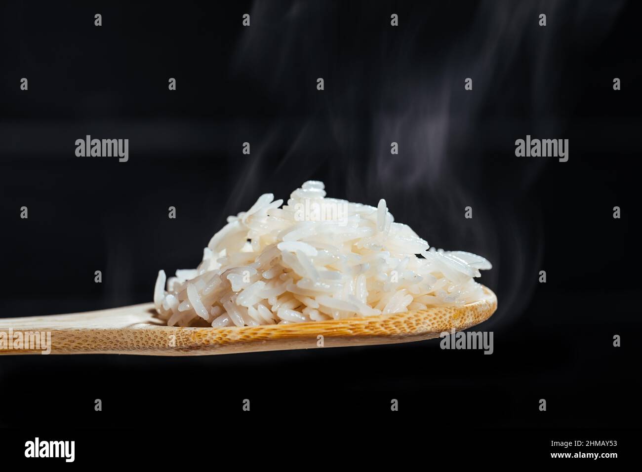 Basmati rice, cooked and raw in different bowls and placed on different ...