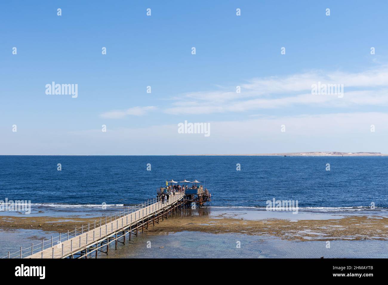 Dilapidated Pier in the Red Sea. Tiran Island on Backdrop. Stock Photo