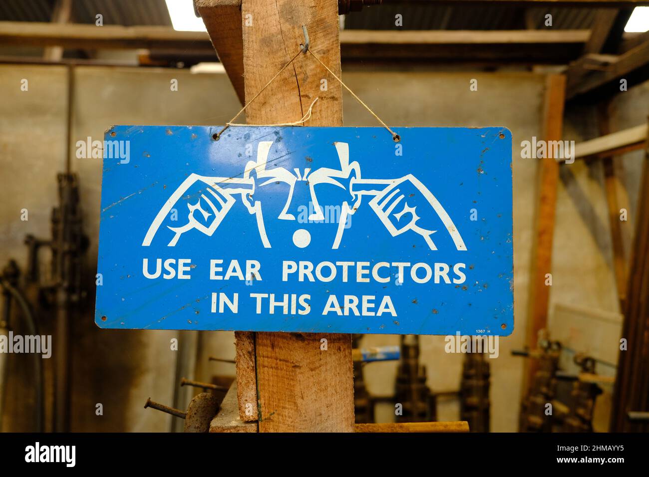 Metal sign warning to user ear protectors due to loud noises Stock Photo