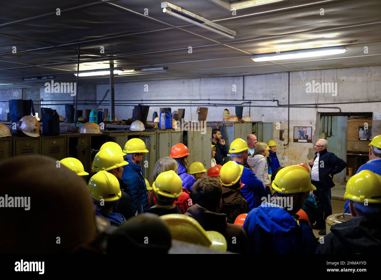 St Agnes, UK - 2018: Visitors of the Wheal Coates tin mine site, wearing hard hats and listening to one of the local guides Stock Photo