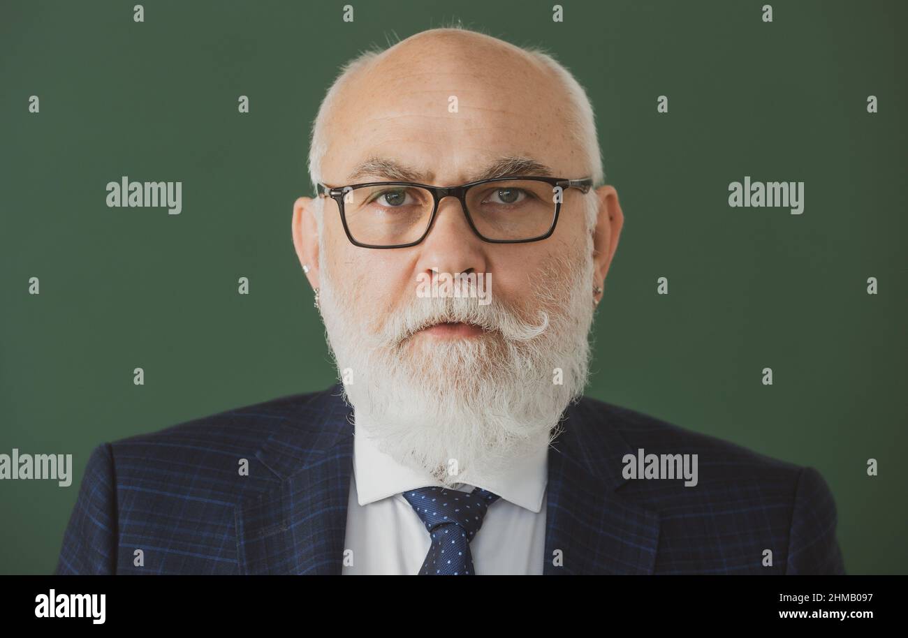 Closeup portrait of senior academic professor on lecture near empty ...