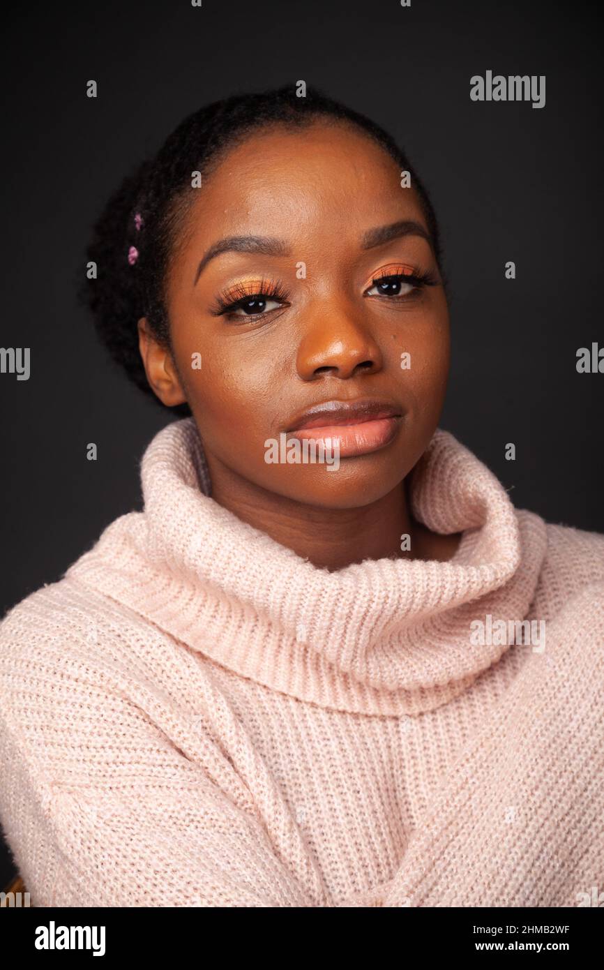 A beautiful black woman wearing a turtleneck sweater. Stock Photo